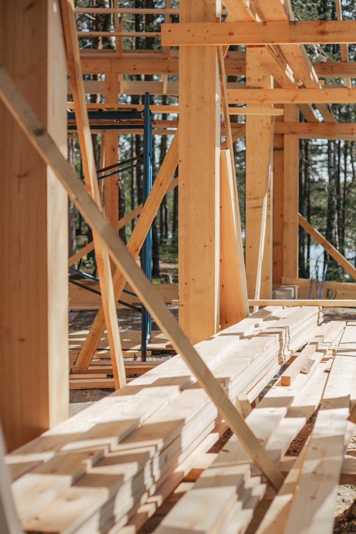 services-05 Sunlit construction site with wooden lumber arranged in rows. Perfect for building projects.