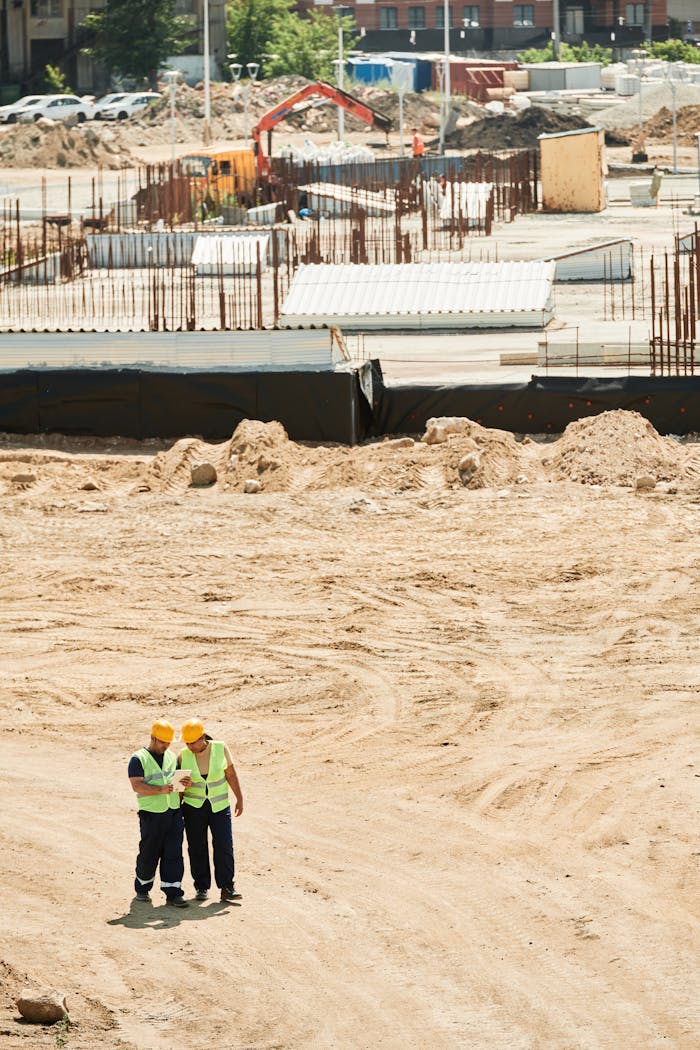 services-10 Aerial view of workers at a construction site with safety gear and equipment.